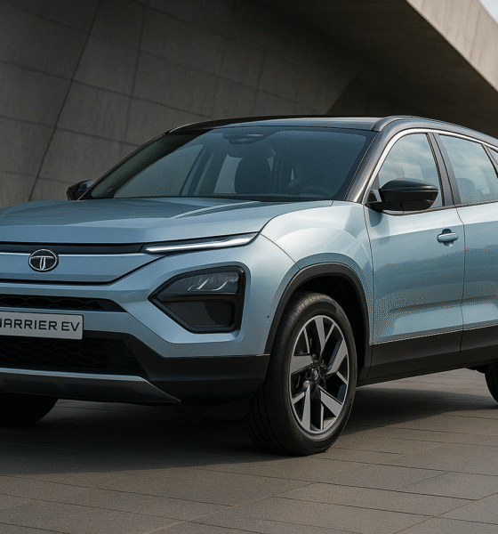 Tata Harrier EV parked outdoors showing front-side view with blue body and bold design.