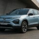 Tata Harrier EV parked outdoors showing front-side view with blue body and bold design.